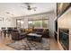 Open-concept living room adjacent to dining area with natural light at 41202 N Rolling Green Way, Anthem, AZ 85086