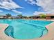 Resort-style pool with lap lanes, lounge seating, and covered cabanas against a backdrop of blue sky and scattered clouds at 41202 N Rolling Green Way, Anthem, AZ 85086