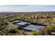 Aerial view of tennis courts in lush landscape with distant mountain views, offering an active outdoor lifestyle at 41202 N Rolling Green Way, Anthem, AZ 85086