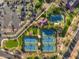 Aerial view of well-maintained community tennis courts with landscaping, providing a space for athletic activities at 41202 N Rolling Green Way, Anthem, AZ 85086