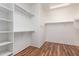 Spacious walk-in closet with built-in shelving and laminate floors at 41202 N Rolling Green Way, Anthem, AZ 85086