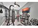 Well-equipped home gym featuring a treadmill, punching bag, weights, and a mounted television at 4232 S 103Rd Ln, Tolleson, AZ 85353