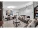Elegant living room with stylish furnishings, a decorative chandelier, and wood-look tile floors at 4232 S 103Rd Ln, Tolleson, AZ 85353