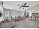 Open concept living space with a large sofa, wood-look tile floors, and view to the kitchen at 4232 S 103Rd Ln, Tolleson, AZ 85353