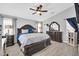 Comfortable main bedroom featuring a large bed, ceiling fan, and an ornate mirror at 4232 S 103Rd Ln, Tolleson, AZ 85353