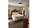 Spacious main bedroom with wood furniture, soft lighting, and a large bed, creating a comfortable and inviting retreat at 426 W Pontiac W Dr # 4, Phoenix, AZ 85027
