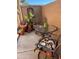 Cozy patio area with a glass table, two chairs, and potted plants offers a relaxing outdoor space at 426 W Pontiac W Dr # 4, Phoenix, AZ 85027