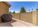 Backyard with brick pavers, rock landscape, and a barbecue at 4349 E Selena Dr, Phoenix, AZ 85050