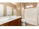 Bathroom featuring a single sink vanity, toilet, and a shower-tub combo at 4349 E Selena Dr, Phoenix, AZ 85050