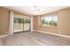 Bright bedroom featuring wood floors, a large window and sliding door with access to the backyard at 4349 E Selena Dr, Phoenix, AZ 85050