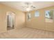 Spacious bedroom features ample natural light from three windows and an en-suite bathroom at 4349 E Selena Dr, Phoenix, AZ 85050