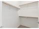 A walk-in closet featuring a carpeted floor and wooden shelves for storage at 4349 E Selena Dr, Phoenix, AZ 85050