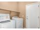 Laundry room featuring a washer and dryer with shelf and door at 4349 E Selena Dr, Phoenix, AZ 85050