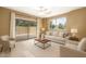 Bright living room features neutral tones, a ceiling fan, and access to an outdoor patio through sliding glass doors at 4349 E Selena Dr, Phoenix, AZ 85050