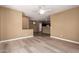 Open-concept living room with wood flooring offering a view into the kitchen and dining area at 4349 E Selena Dr, Phoenix, AZ 85050