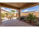 Spacious covered patio area with desert landscaping, a hot tub, and outdoor seating to enjoy the Arizona weather at 45028 W Cypress Ln, Maricopa, AZ 85139