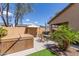 Relaxing backyard featuring an outdoor seating area, hot tub, artificial grass, and desert landscaping at 45028 W Cypress Ln, Maricopa, AZ 85139