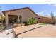 Backyard featuring a patio, dining area, a hot tub, and desert landscaping for easy maintenance at 45028 W Cypress Ln, Maricopa, AZ 85139