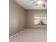 Bedroom featuring a window and neutral carpet, perfect for relaxation at 45028 W Cypress Ln, Maricopa, AZ 85139