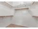 Walk-in closet with ample shelving and rod space for organized storage at 45028 W Cypress Ln, Maricopa, AZ 85139