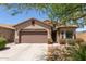Charming single-story home with a two-car garage and a well-maintained front yard at 45028 W Cypress Ln, Maricopa, AZ 85139