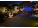 Hot tub in a desert landscaped yard, lit at night with glowing blue LED lighting at 45028 W Cypress Ln, Maricopa, AZ 85139