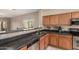 Open kitchen design with dark countertops, stainless steel appliances, and a raised bar at 45028 W Cypress Ln, Maricopa, AZ 85139