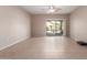 Open living space with tile floors, a ceiling fan, and access to the outdoor patio through sliding glass doors at 45028 W Cypress Ln, Maricopa, AZ 85139