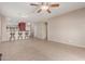 Open-concept living area with tile flooring, neutral walls, and a view into the kitchen area at 45028 W Cypress Ln, Maricopa, AZ 85139