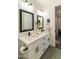 Stylish bathroom boasts a dual sink vanity with black fixtures, mirrors, and modern lighting at 4817 N 35Th St, Phoenix, AZ 85018