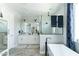 Bright bathroom showcasing a tub, a glass shower, and a double vanity with modern fixtures and finishes at 4817 N 35Th St, Phoenix, AZ 85018