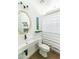 Stylish bathroom featuring a modern sink, gold mirror, and contemporary striped shower curtain at 4817 N 35Th St, Phoenix, AZ 85018