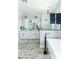 Bright bathroom showcasing a tub, a glass shower, and a double vanity with modern fixtures and finishes at 4817 N 35Th St, Phoenix, AZ 85018