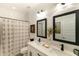 Bright bathroom features a double vanity with a shower and framed mirrors with decorative accents at 4817 N 35Th St, Phoenix, AZ 85018