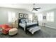 Charming bedroom with a dark wooden bed frame and carpet, featuring a ceiling fan and bright windows at 4817 N 35Th St, Phoenix, AZ 85018