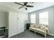 Neutral bedroom features a built-in Murphy bed, a beige sofa, and plenty of natural light at 4817 N 35Th St, Phoenix, AZ 85018
