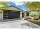 Stunning modern home with a black garage door, bright white siding, and manicured landscaping at 4817 N 35Th St, Phoenix, AZ 85018