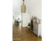 Stylish hallway featuring unique light fixture, custom decor, and hardwood floors that lead into the home at 4817 N 35Th St, Phoenix, AZ 85018