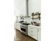 Close up of kitchen with stainless steel appliances, floating wood shelves, and white cabinets at 4817 N 35Th St, Phoenix, AZ 85018