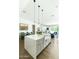 Open-concept kitchen with a large island, farmhouse sink, and seating, flowing to dining and living areas at 4817 N 35Th St, Phoenix, AZ 85018