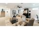 Spacious living room with a sofa, chairs, ceiling fan, and a bar area, perfect for relaxation and entertainment at 4817 N 35Th St, Phoenix, AZ 85018