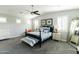 Serene bedroom with a ceiling fan, shuttered windows, and a comfortable bed with decorative pillows at 4817 N 35Th St, Phoenix, AZ 85018