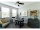 Bright office features grey walls, carpet, art pieces, ceiling fan, and a desk near the windows at 4817 N 35Th St, Phoenix, AZ 85018