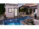 Captivating view of the modern pool with an outdoor kitchen and dining area, creating an entertainer's dream at 4817 N 35Th St, Phoenix, AZ 85018