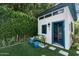 Charming backyard shed with blue trim, complemented by a cozy bench and manicured landscaping at 4817 N 35Th St, Phoenix, AZ 85018
