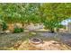 Backyard with mature trees and a fire pit, offering a relaxing outdoor space at 5126 W Las Palmaritas Dr, Glendale, AZ 85302