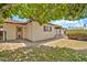 Charming backyard with lush green grass and mature trees providing ample shade at 5126 W Las Palmaritas Dr, Glendale, AZ 85302