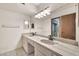 Bathroom featuring a double sink vanity, ample counter space, and access to a glass-enclosed shower at 5126 W Las Palmaritas Dr, Glendale, AZ 85302