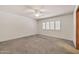 This bright bedroom features a ceiling fan and window with plantation shutters at 5126 W Las Palmaritas Dr, Glendale, AZ 85302