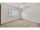 The bedroom features a ceiling fan and a window with plantation shutters at 5126 W Las Palmaritas Dr, Glendale, AZ 85302